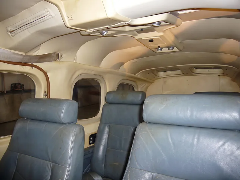 Before (AI illustration): a typical worn cabin with faded blue-gray seats